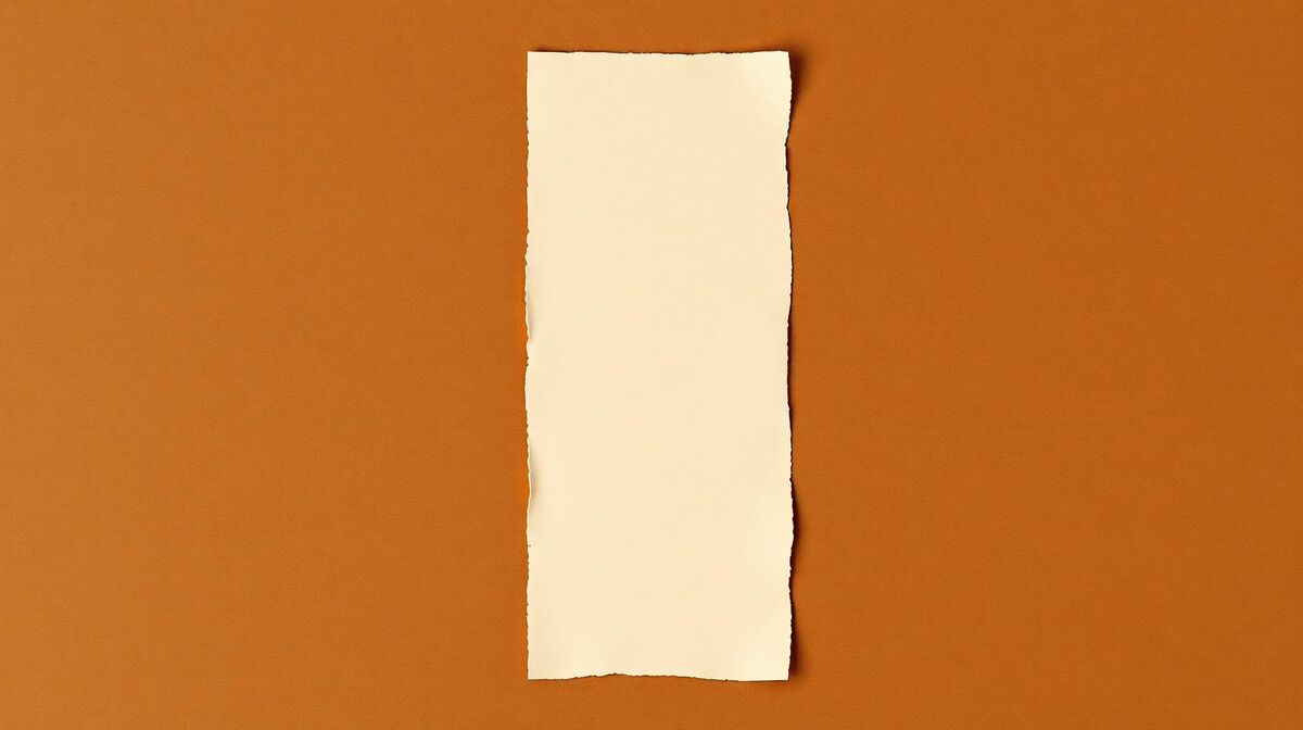 A torn cream document on warm brown ground.